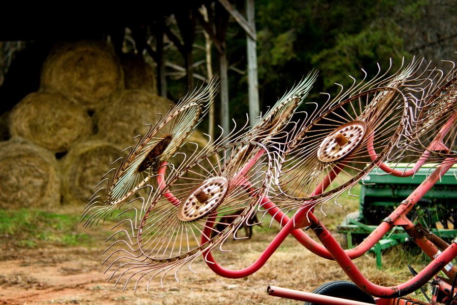 Hay bales and a hay rake on a farm